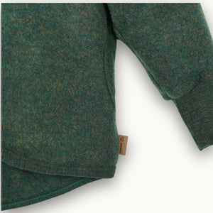Forest green organic cotton baby onesie with ribbed cuffs and neckline, featuring a natural fabric tag.