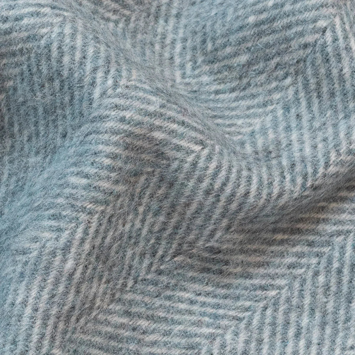Tissu de couverture en laine ALPAKA bleu clair et blanc à motif chevrons montrant une texture bicolore éco-responsable