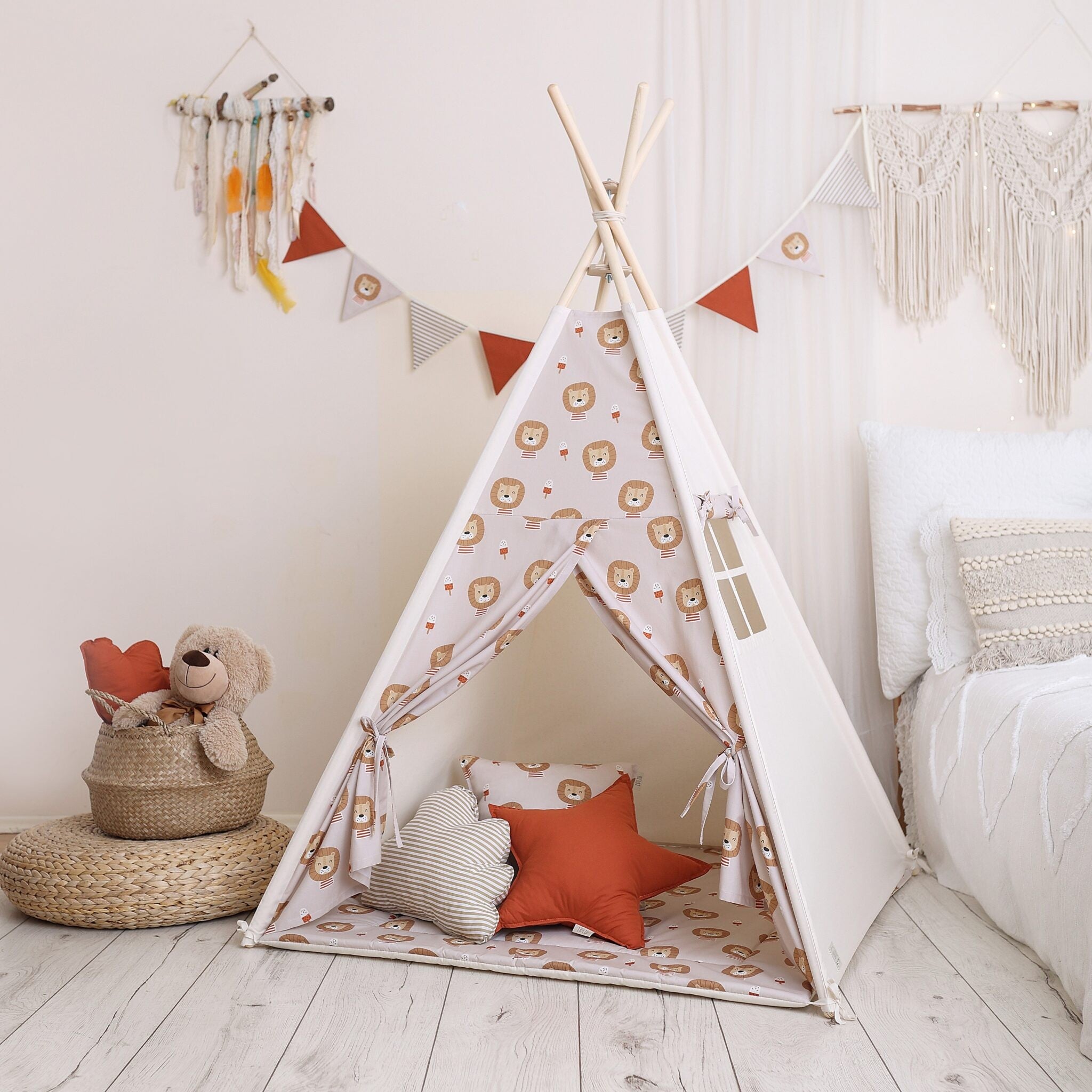 Lion-patterned cotton teepee tent styled with soft star and cloud cushions