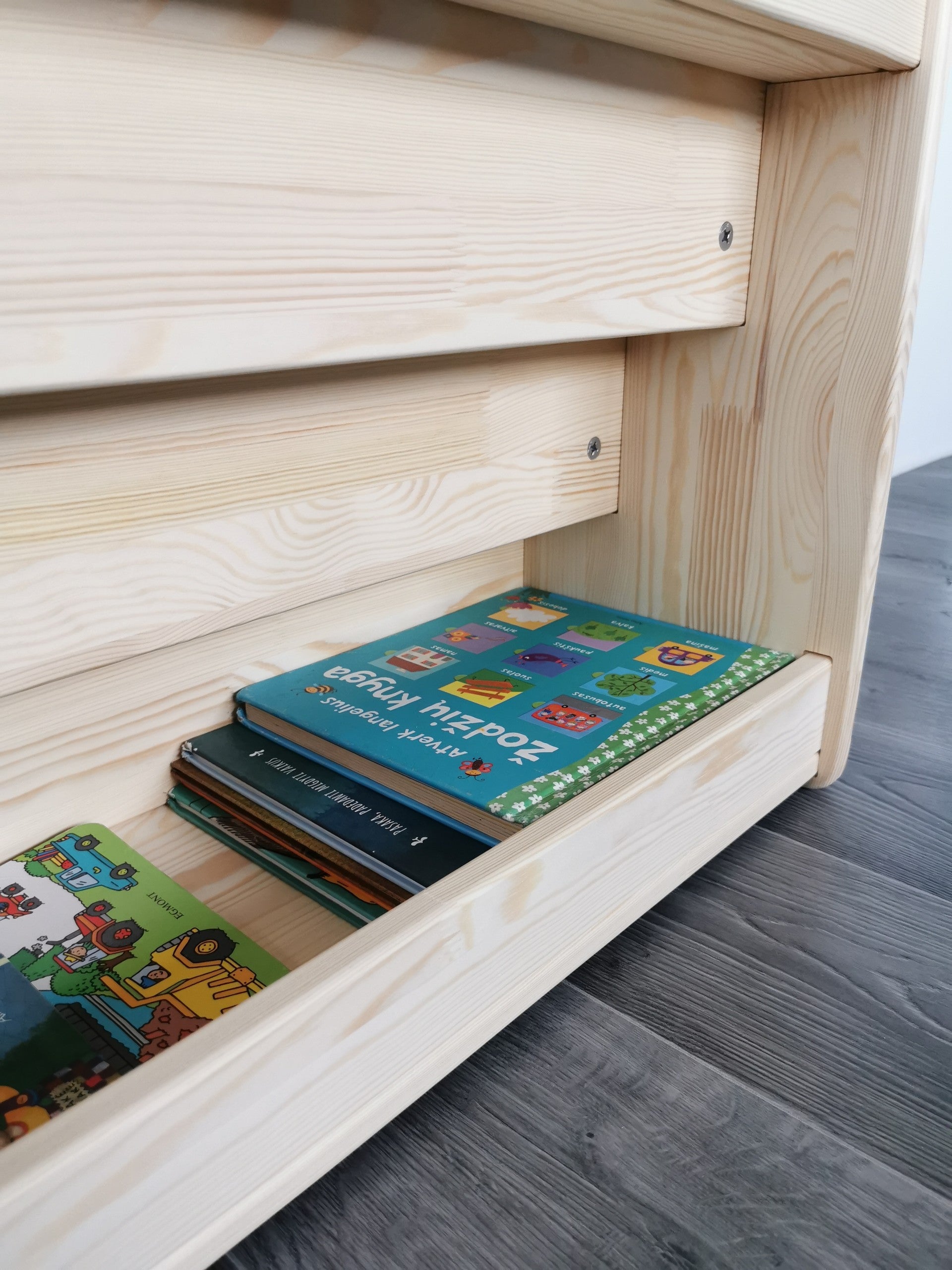 Close-up of deep rear book storage compartment on the One Little Pine Montessori bookshelf