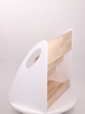 Rear product view of white and natural wood Montessori bookshelf showing additional storage compartment