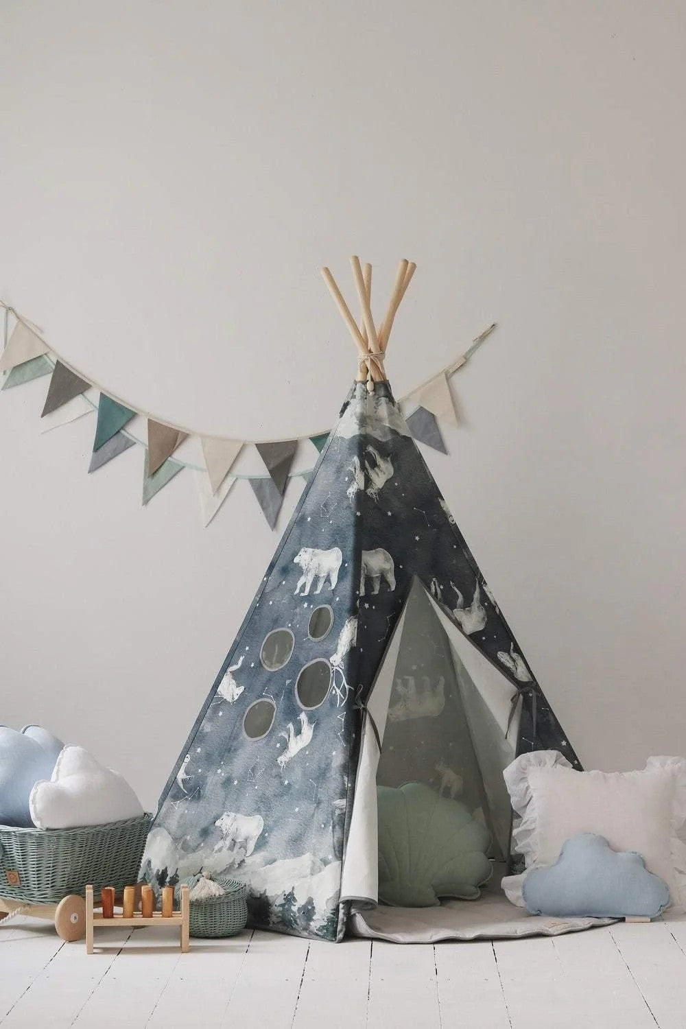 Moi Mili Night Sky teepee styled with cloud cushions, woven baskets and a wooden toy in a bright children’s room