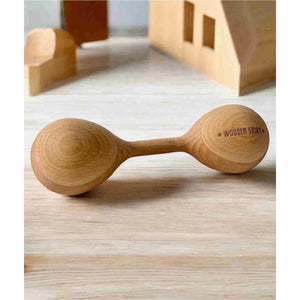 Wooden baby rattle with "Wooden Story" engraving, natural finish, smooth grain texture on light wood surface