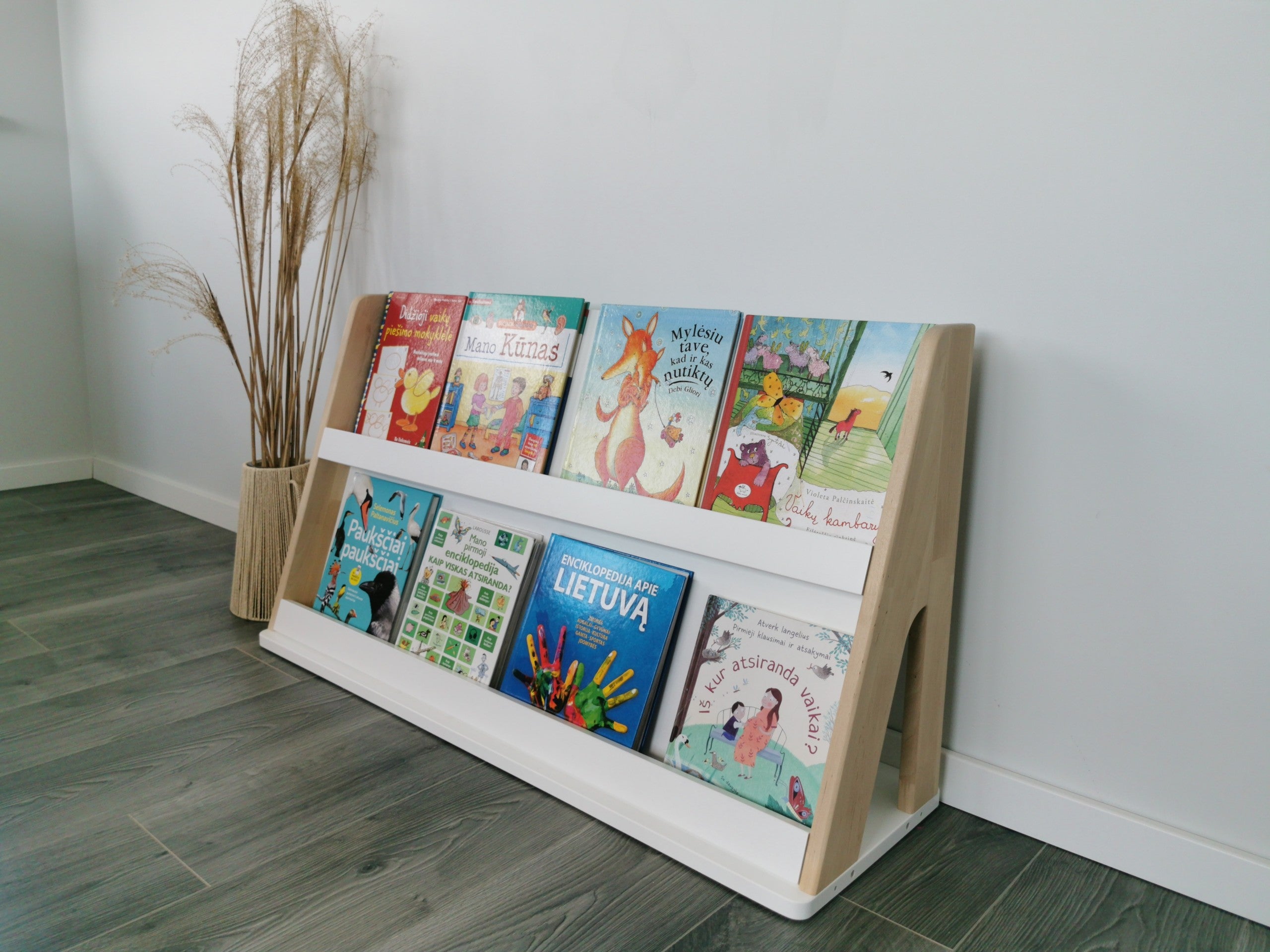 One Little Pine two-shelf Montessori bookshelf displaying children’s books front-facing in a calm reading corner