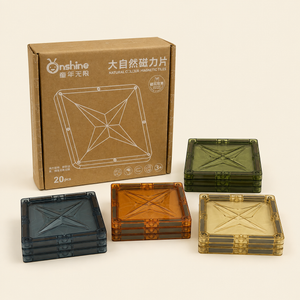 Onshine Natural Colour Magnetic Tiles 20-piece set with square translucent blue, amber, green and golden tiles beside packaging