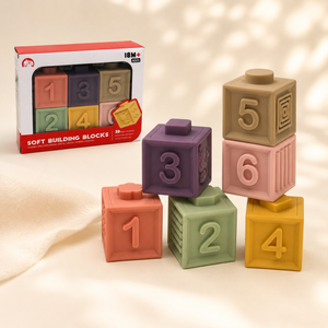 Pastel silicone number blocks stacked beside 18M+ Soft Building Blocks packaging