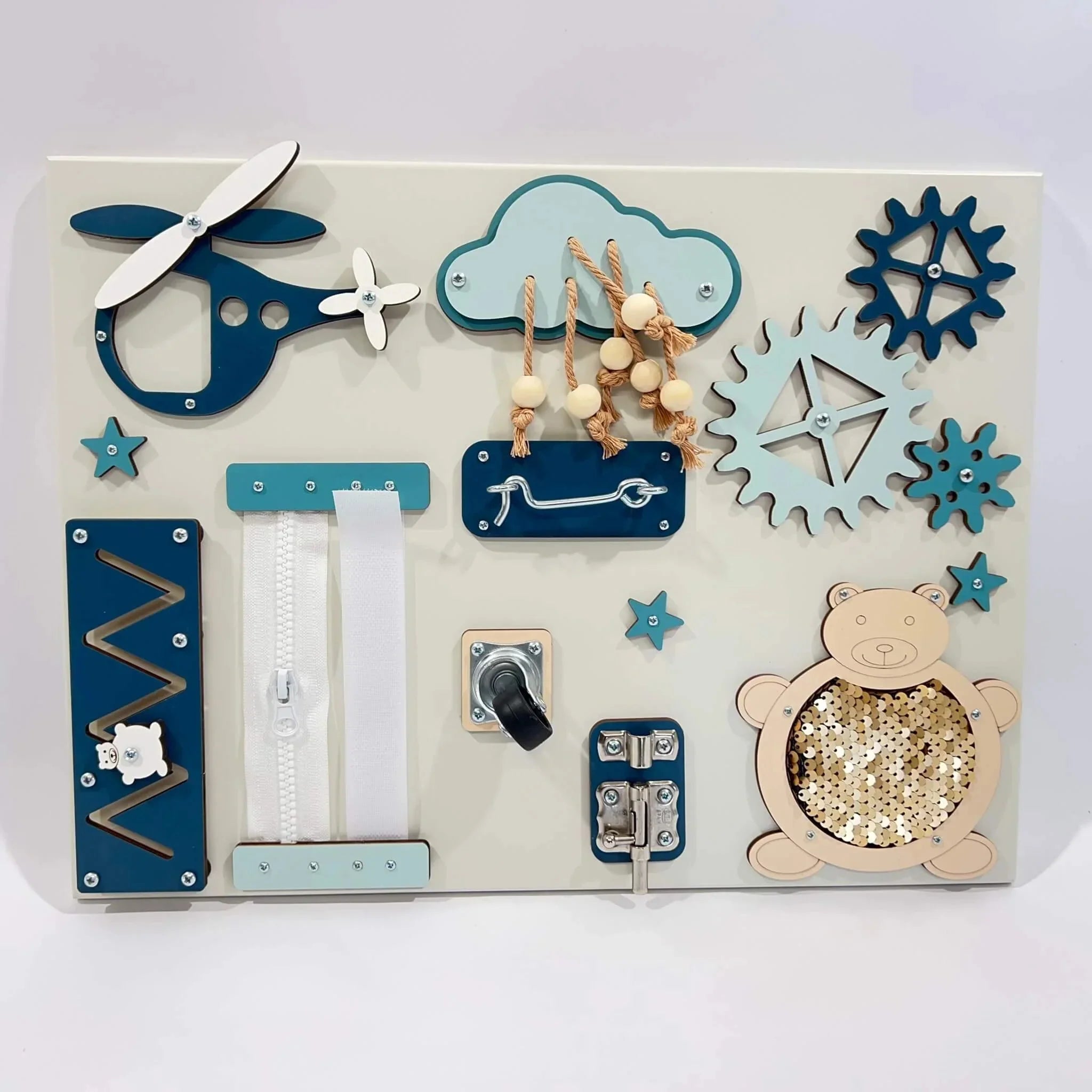 Wooden sensory activity board with airplane, gears, zipper, cloud beads, and sequin bear in blue and cream