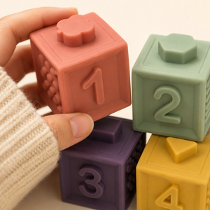 Close-up of soft silicone number blocks showing raised numbers, tactile patterns and different top shapes
