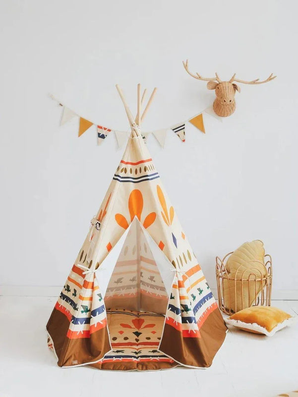Tienda tipo tipi infantil estilo boho con patrones geométricos, postes de madera y toques en naranja y marrón para la habitación.