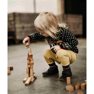 Child stacking natural wood building blocks, European handmade nursery toy