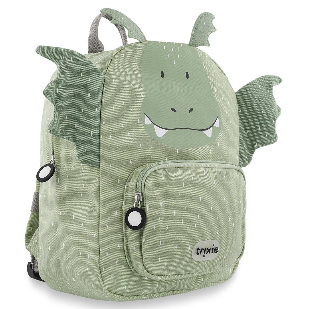 Three-quarter view of Trixie Mr. Dragon backpack showing green dragon wings, horns and large zipper pulls