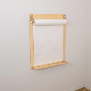 Light wood wall-mounted drawing paper roll holder with built-in shelf, ideal for nursery or kids' art space