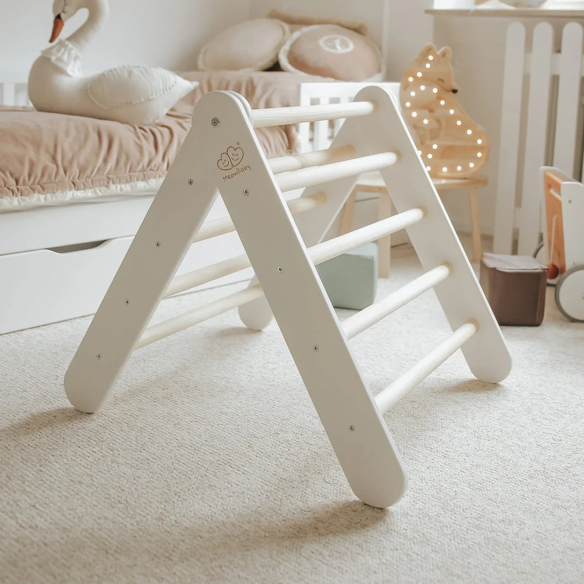 White wooden climbing frame with natural rungs in a calm playroom