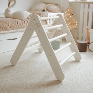 White wooden climbing frame with natural rungs in a calm playroom