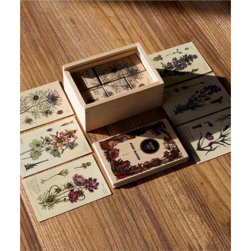 Wooden box with vintage botanical print story blocks, floral illustrations on cream cards, European artisan home decor